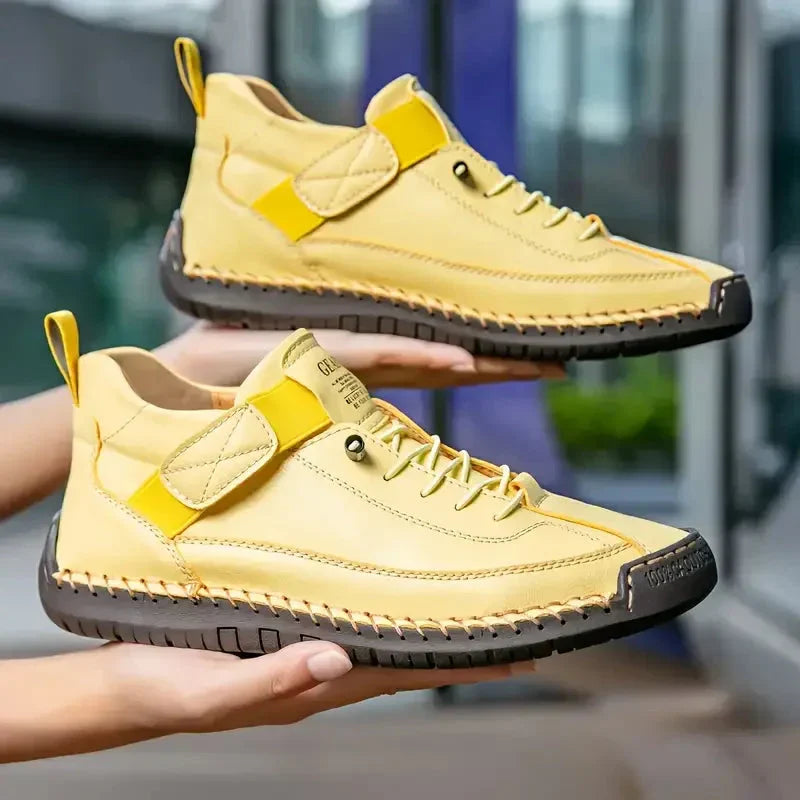 Clover comfort sneakers held in hand to show how lightweight they are